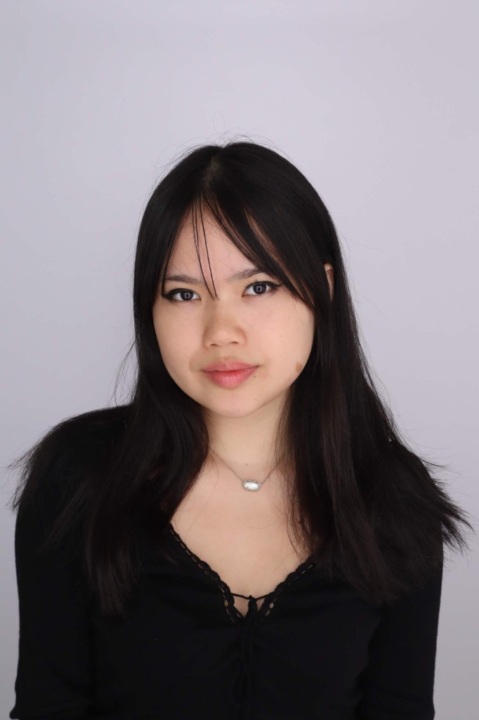 Portrait of Jessica Ha, HackBU organizer, in a black top and pendant necklace against a plain backdrop.